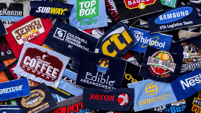 Many embroidered logos piled on top of each other