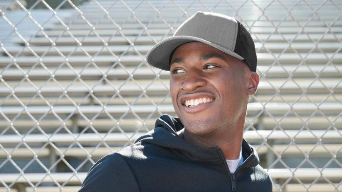 Man wearing a gray trucker hat